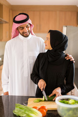 arabian couple cooking in home kitchen