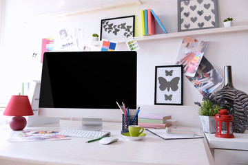 Modern computer on the table in decorated room