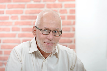portrait of a smiling senior with a beard