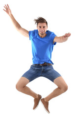Active guy jumping in joy, isolated on white