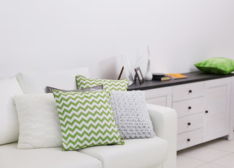 Sofa with colorful pillows in room