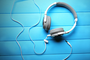 Headphones on blue wooden background