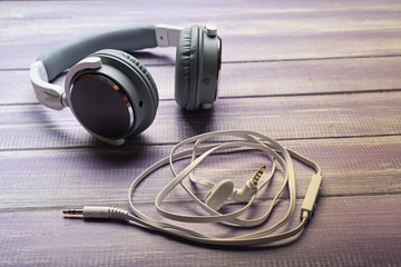 Headphones on wooden lilac background