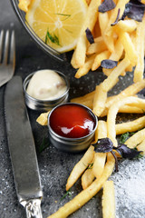 French fries with sauce and tableware on table