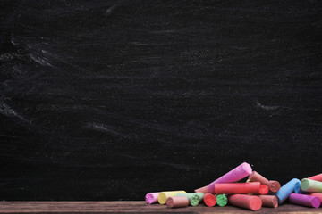 Multicoloured chalk on blackboard background