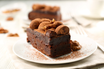 Piece of chocolate cake with walnut on the table, close-up