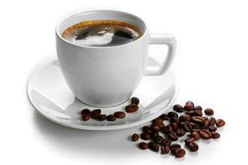 A cup of tasty drink and scattered coffee grains, isolated on white