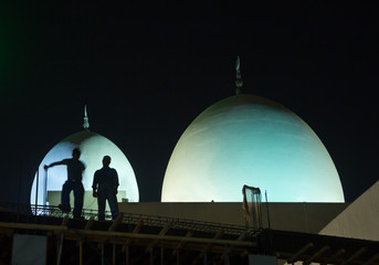 Naklejka premium construction workers working in the middle of the night in deira, dubai untied arab emirates
