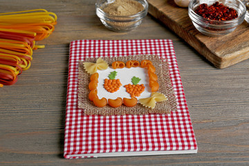 Designed cookbook with food ingredients on the kitchen table, close up