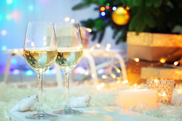 Two champagne glasses on christmas decor background