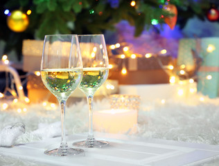 Two champagne glasses on christmas decor background