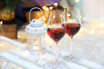 Two glasses of wine on christmas decor background