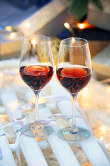 Two glasses of wine on christmas decor background