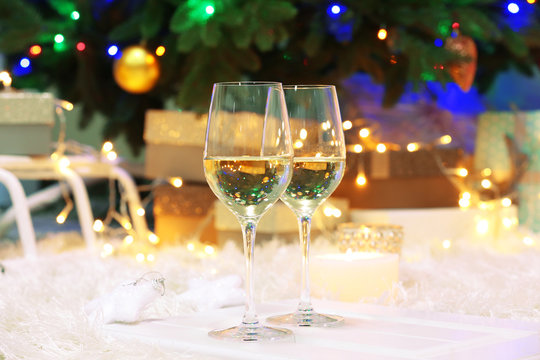 Two champagne glasses on christmas decor background