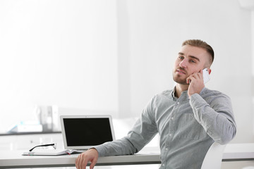 Businessman working with laptop in office