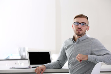 Businessman working with laptop in office