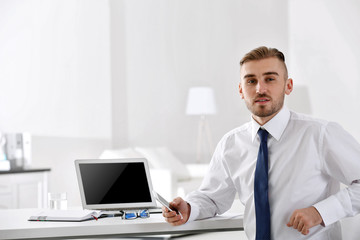 Businessman working with laptop in office