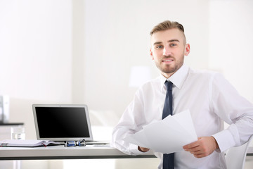 Businessman working with laptop in office