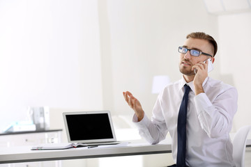 Businessman working with laptop in office