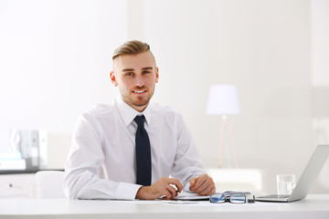 Businessman working with laptop in office