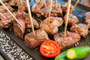 grilled barbecue meat on sticks with vegetables