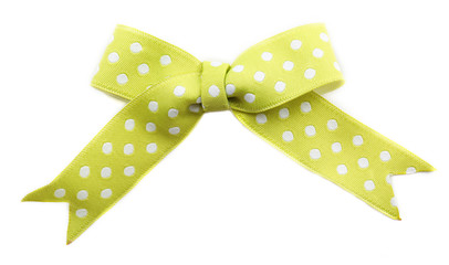 Green dotted bow isolated on white background