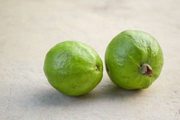 green Guava on cement floor