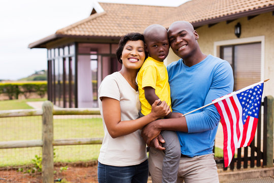 Young Family Holding American Flag