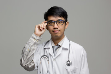 Portrait of Asian doctor with stethoscope on isolated background