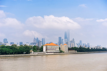 Naklejka premium GUANGZHOU, CHINA - Oct.7: Day view of buildings by the Pearl River. The modern buildings on both sides of the Pearl River make it a beautiful landscape of the city.