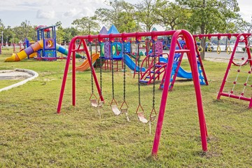 red swing - Playground swing in a park
