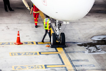 Airplane landing gear wheel parking on ground in airport