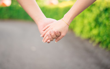 Lovers hand holding together while walking