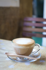 Hot art Latte Coffee in a cup on wooden table