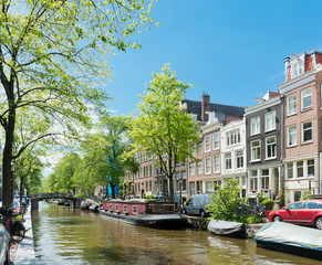 Amsterdam with green canal in the downtown, Holland