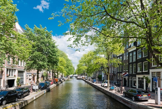 Amsterdam with green canal in the downtown, Holland