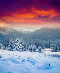 Dramatic winter sunset in the snowy mountains.