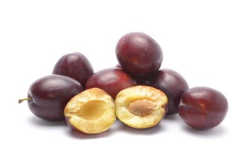 Purple plums isolated on white background