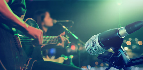 Guitarist on stage with microphone for background, soft and blur concept