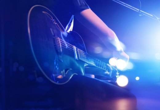 Guitarist on stage for background, soft and blur concept