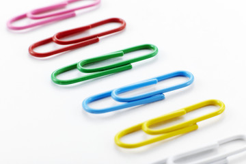 Color paperclips on white background