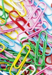 Color paperclips on white background