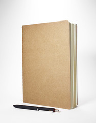 Notebook and pen on white background