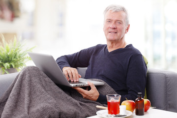 Senior patient man with laptop