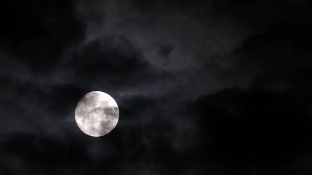 full moon moving between clouds, 4k
