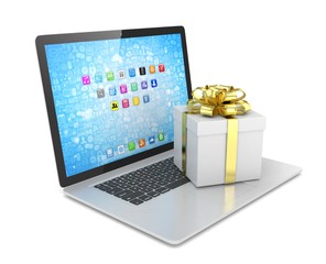 Gift box with ribbon bow on laptop keyboard