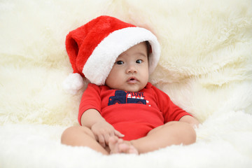 asian cute baby sitting on a soft cloth in the living room. Baby