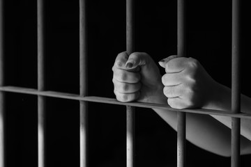 Woman hand in jail