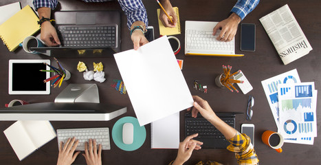 Business People Working on an Office Desk - obrazy, fototapety, plakaty