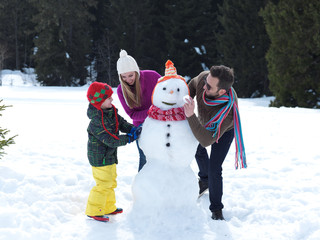happy family making snowman